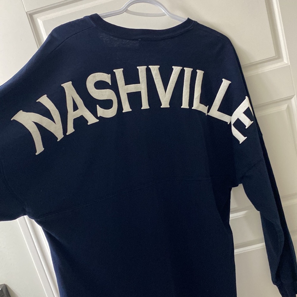 Nashville Spirit Jersey size medium. Navy with white laced v neck and letters